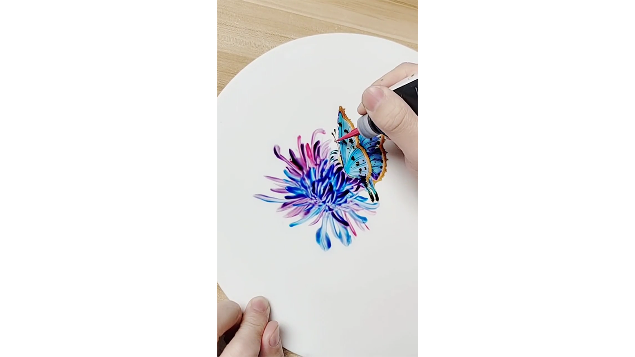 Drawing colorful butterfly on chrysanthemum with ink creating vibrant ...