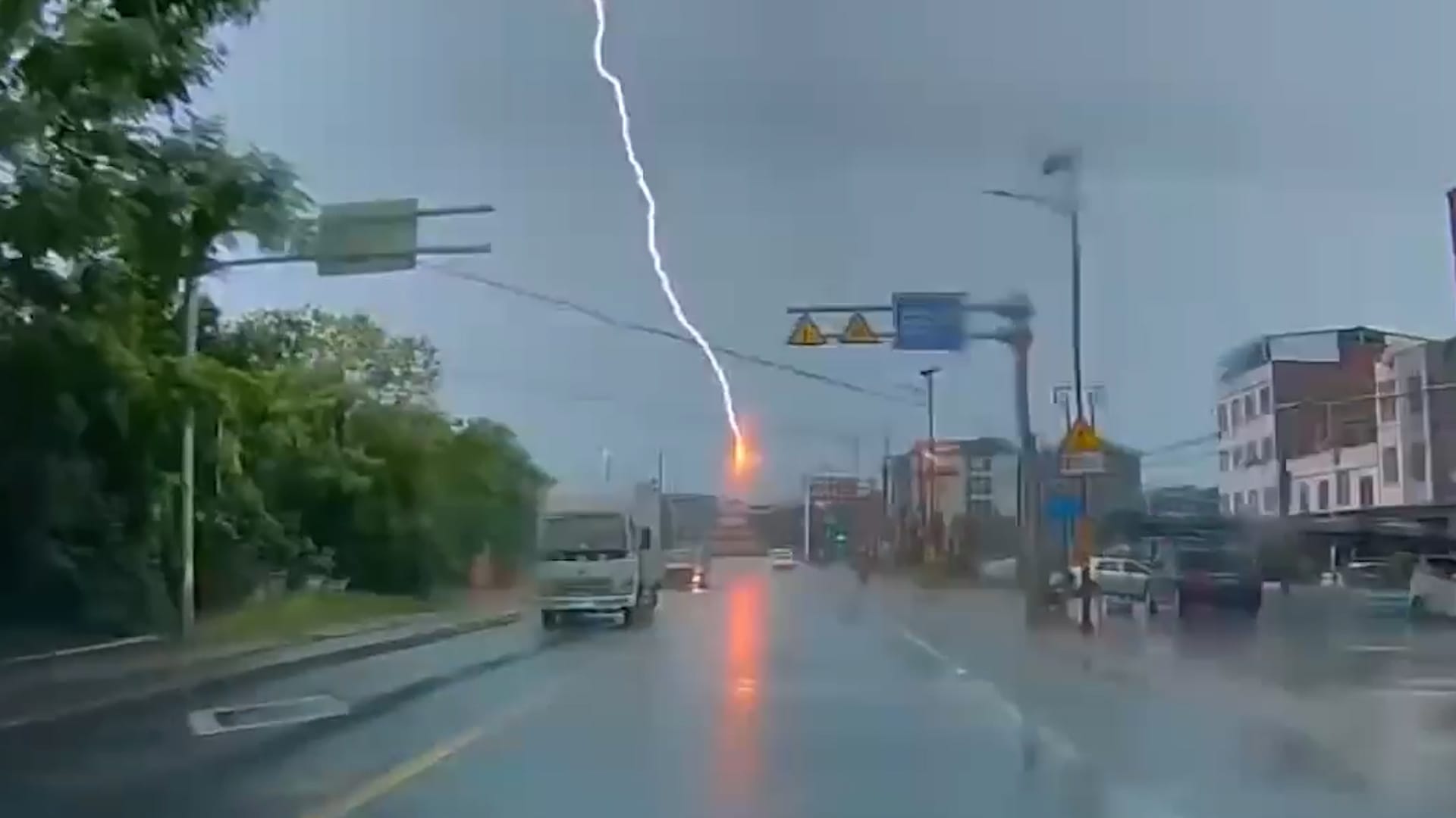 Lightning strikes overhead power line above moving traffic in China