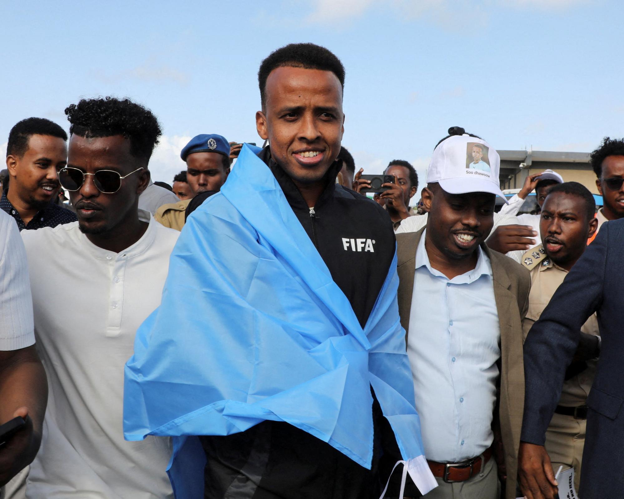 Omar Artan (centre) was given a hero’s welcome when he arrived back in Mogadishu after being denied entry to the US. Photograph: Feisal Omar/Reuters