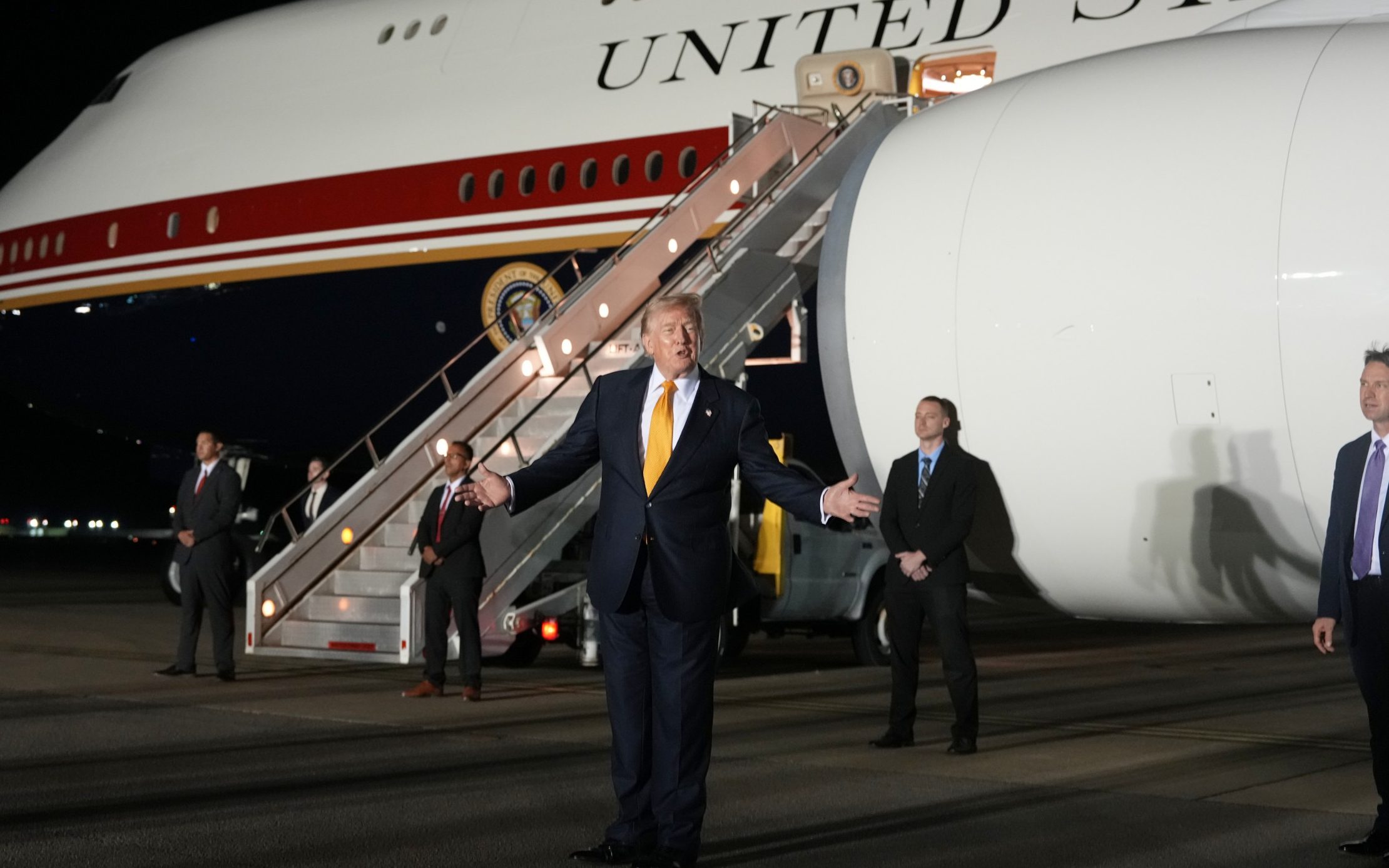 Mr Trump waved at crowds as he boarded Air Force One before being smuggled off the aircraft - Alex Brandon
