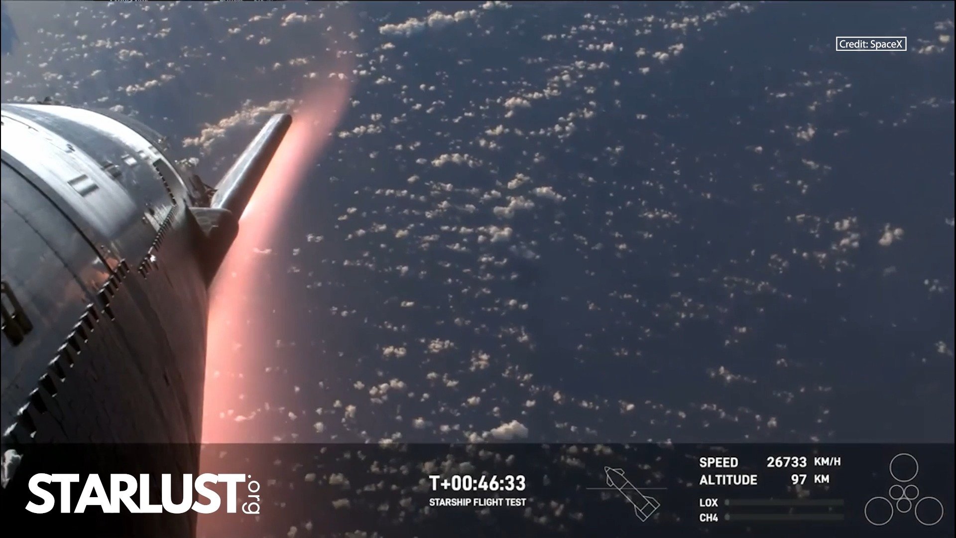 Starship glows orange as it plunges back through Earth’s atmosphere
