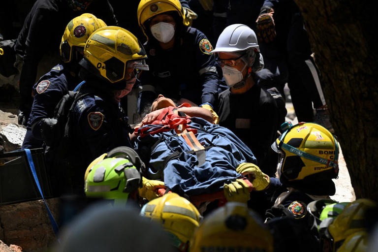 Rescue teams in Colombia dig through rubble to pull out quake victims