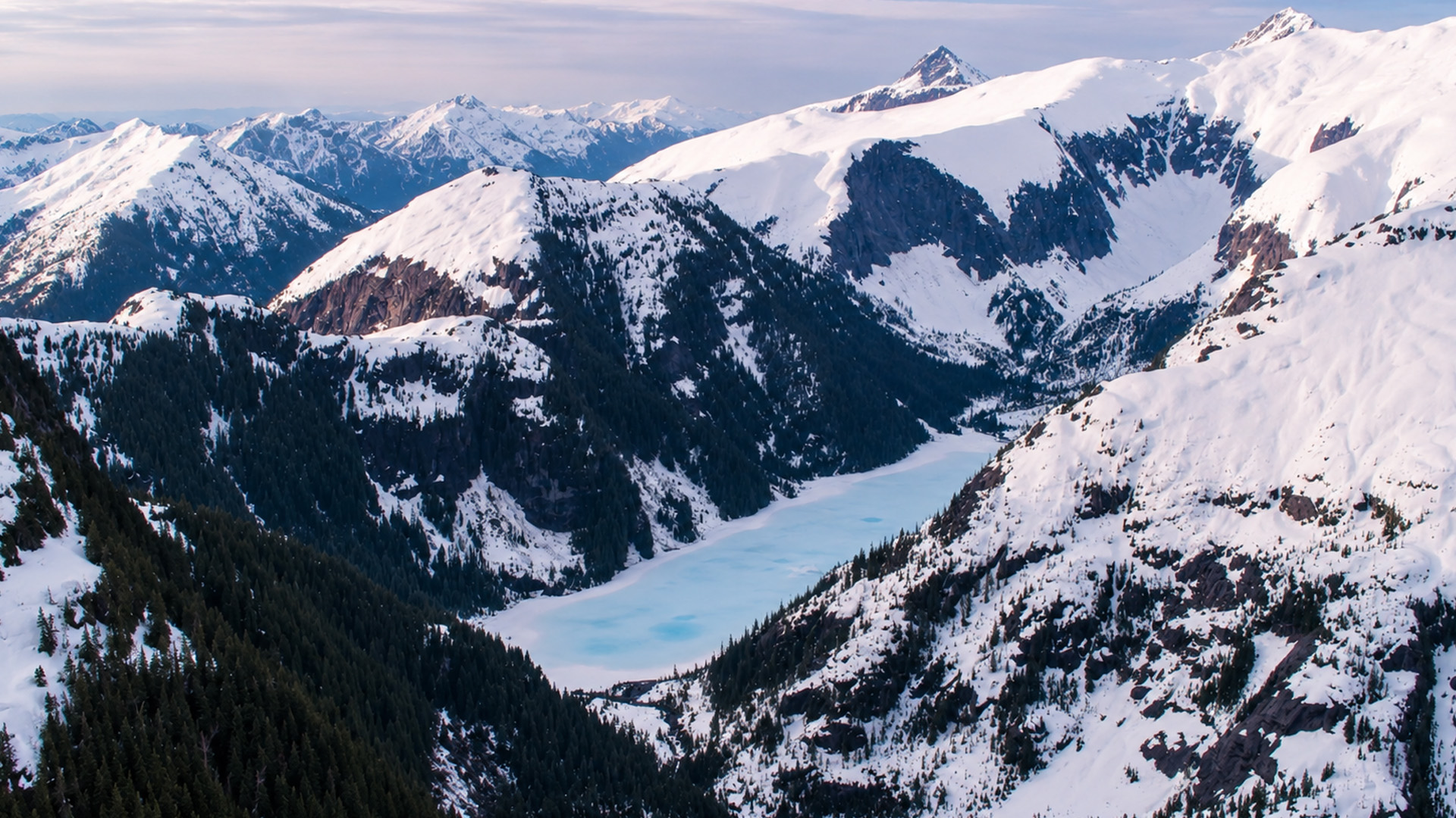 A frozen lake trapped between steep mountains