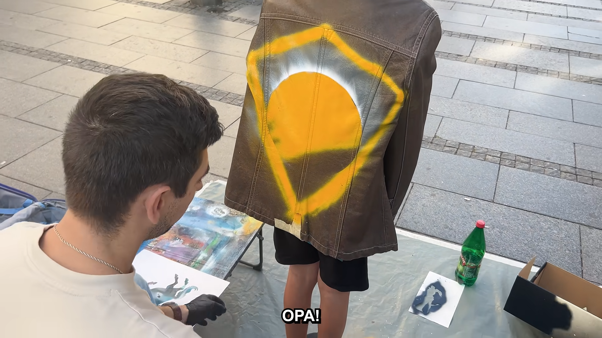 He was selling toys on the street... then we spray painted his jacket