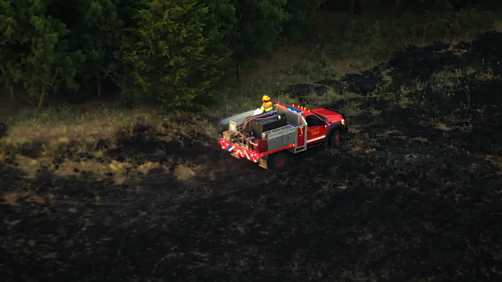 Crews put out grass fire after flames break out near wind turbine in ...