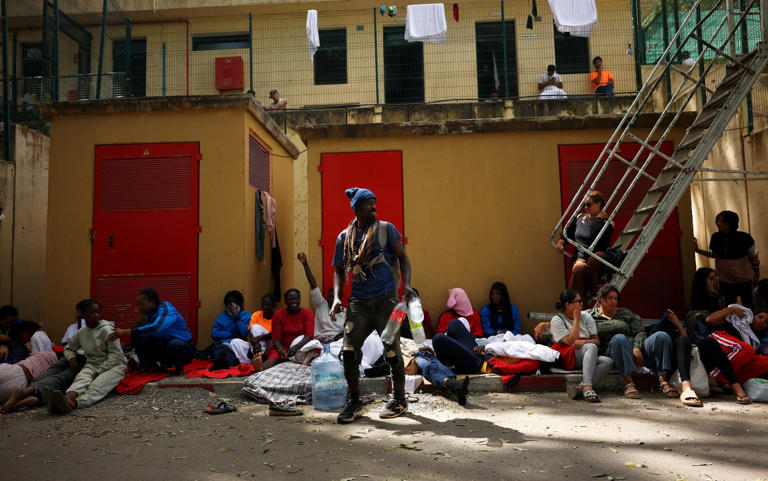 Migrants wait outside Ceuta’s temporary migrant centre - Pedro Nunes/REUTERS