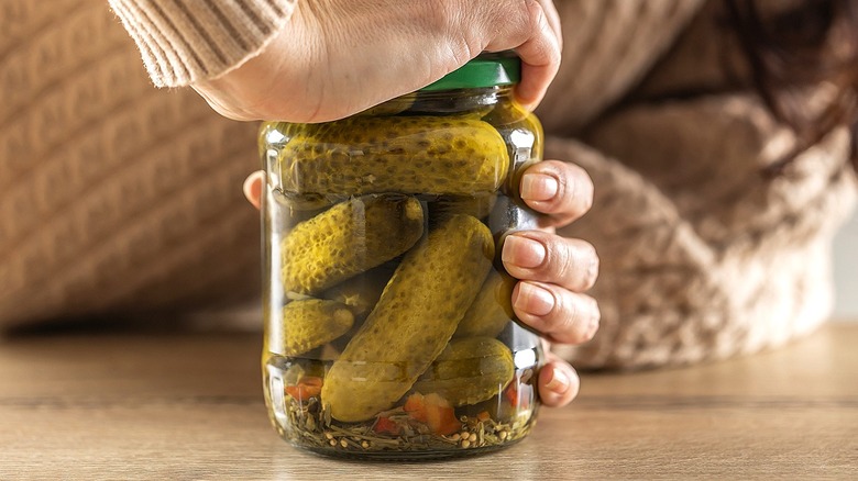 Transform an old pickle jar into rustic kitchen countertop storage