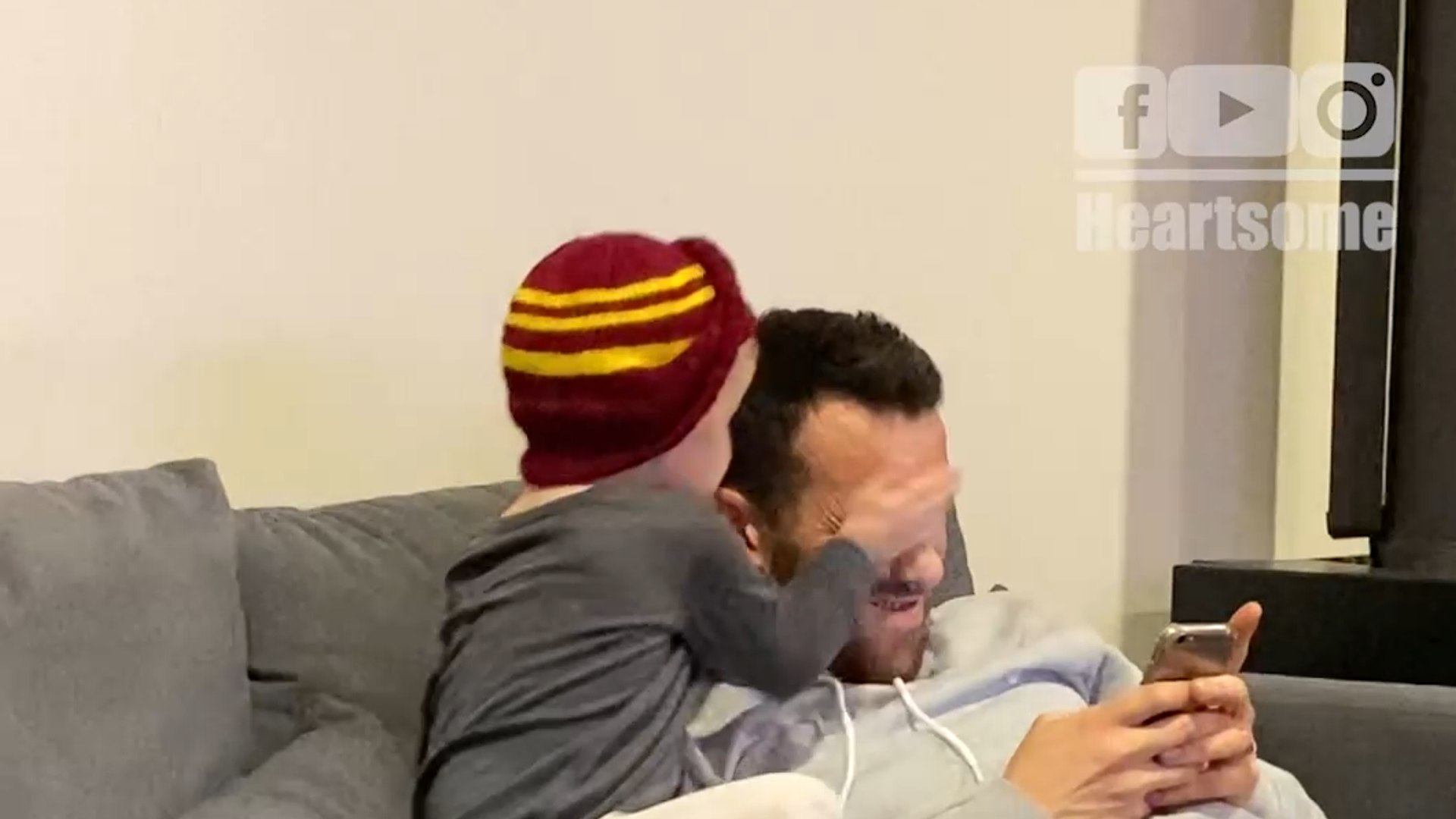 Child playfully slaps father for ignoring his improv role