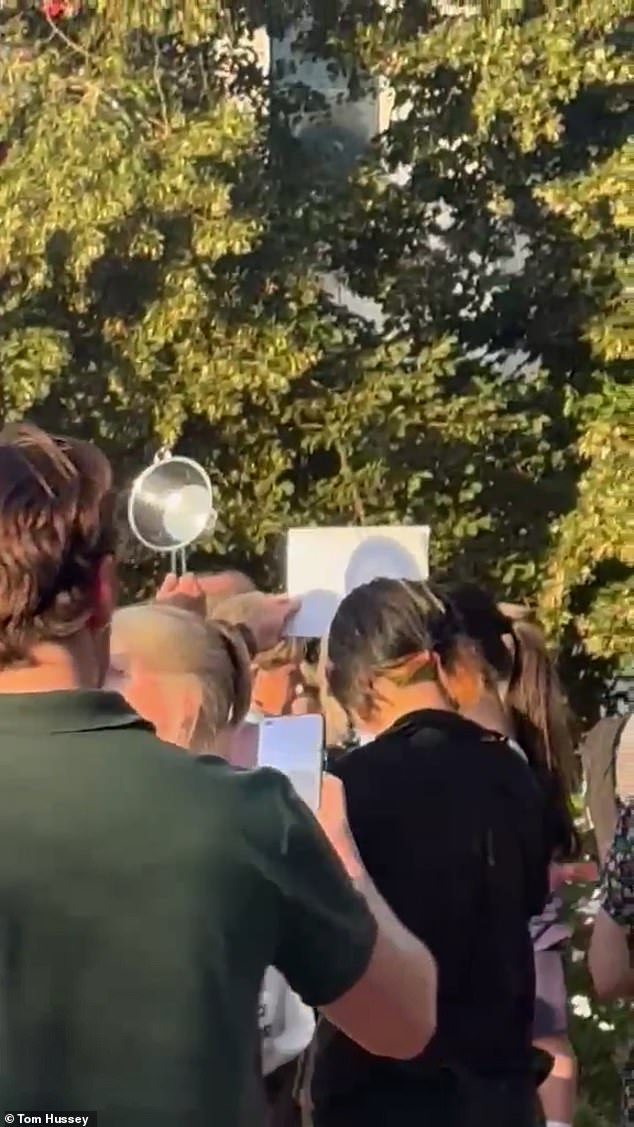 Moment man uses colander at packed London park to watch the eclipse and he's not alone