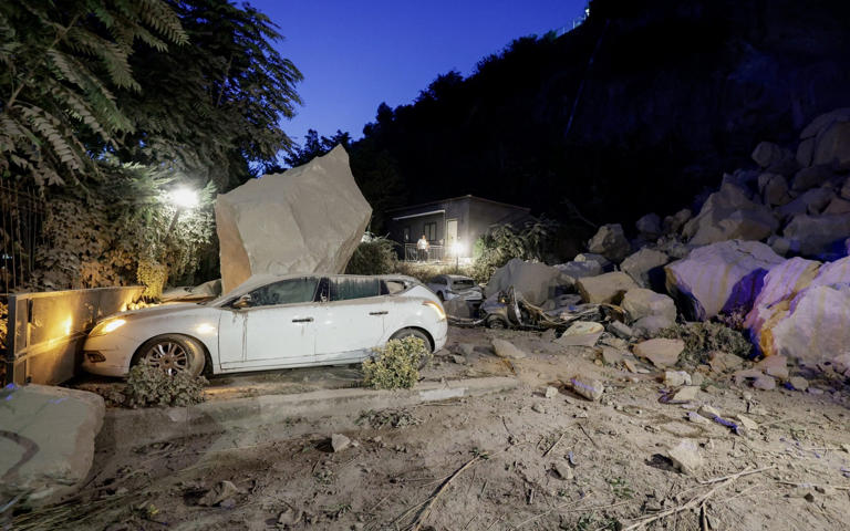 The earthquake caused an enormous rock to land on the car - Salvatore Laporta/REUTERS