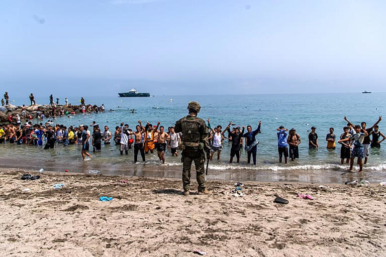 Spanish army soldiers block access to the beach for people crossing from Morocco into the Spanish enclave of Ceuta, Friday, July 31, 2026. Copyright 2026 The Associated Press. All rights reserved.