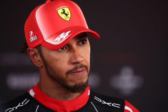 Lewis Hamilton wearing red Ferrari hat