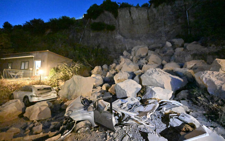 Cars were crushed after boulders fell off cliffs - Felice De Martino/EPA/Shutterstock