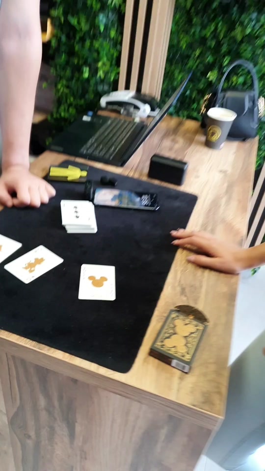 Queen king and the joker at the card table