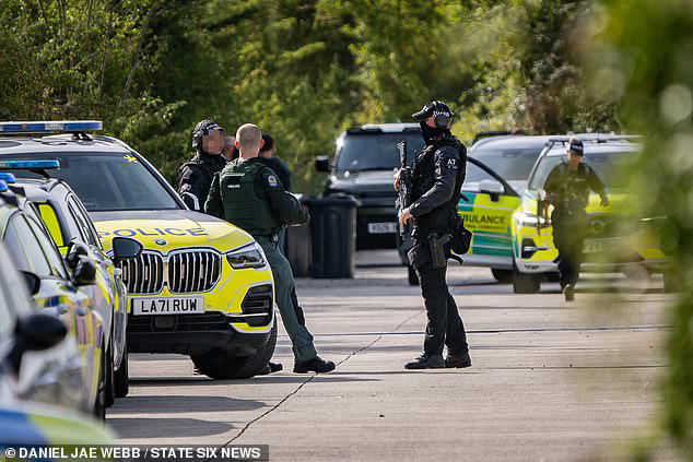 Armed police and paramedics at the traveller site in Calcutt, Wiltshire, where the 30-year-old man was pronounced dead after the alleged shooting