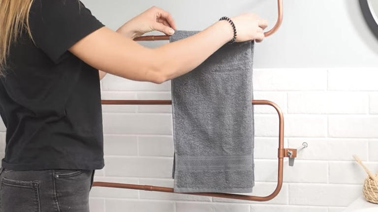 Woman finds a cuter way to hang bathroom towels with a chic DIY