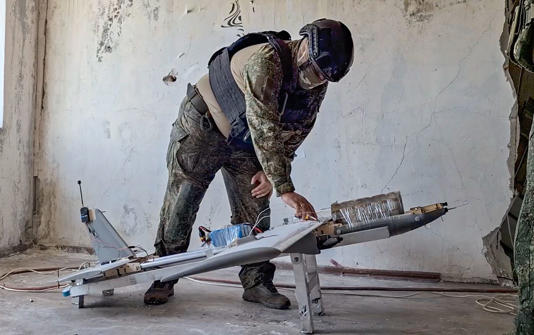A Russian serviceman prepares a drone in this image released by Russia’s government.