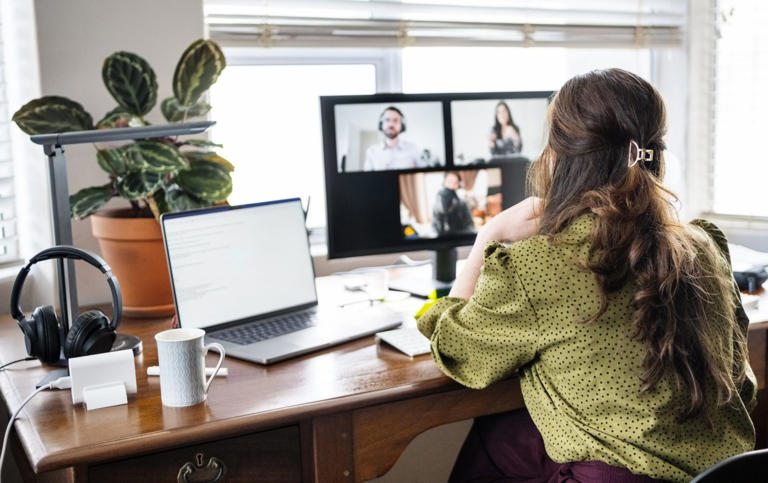 Caption: Rear view of woman having a video call meeting with business team on desktop computer while working remotely from home Photographer: NickyLloyd Provider: Getty Images Source: E+