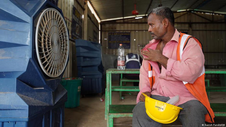 After a day in relentless heat on a construction site, Singh tries to find relief in front of a fan
