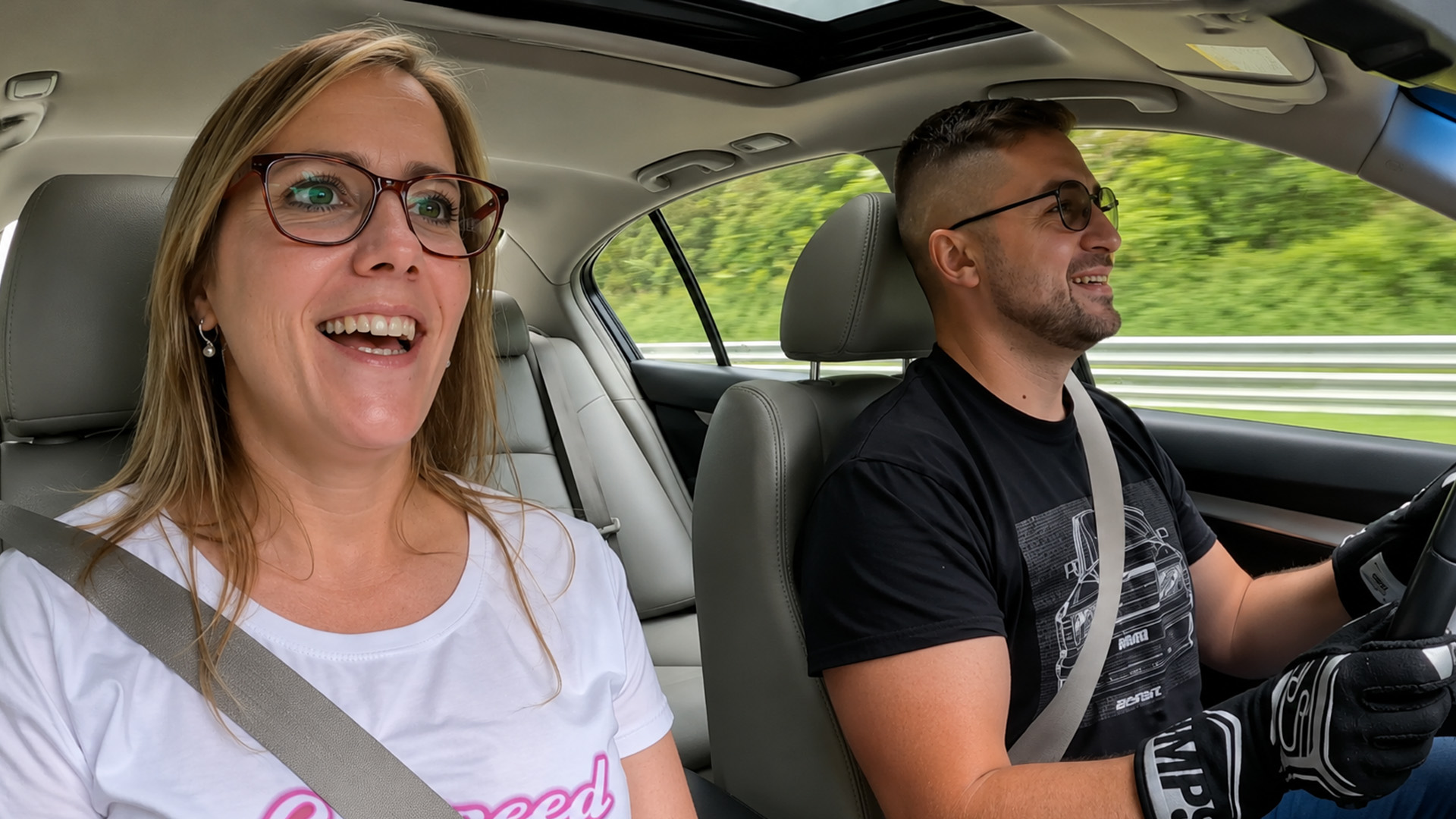 Inside Infiniti G37 S track run with a smiling passenger