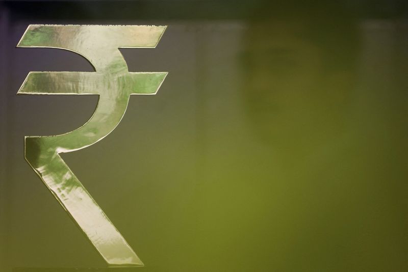 Competing cues, caution ahead of RBI policy decision keep rupee nearly flat
