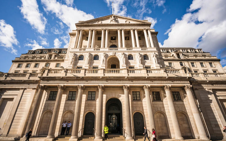 People in front of the UK's central bank, the Bank of England, in the City of London