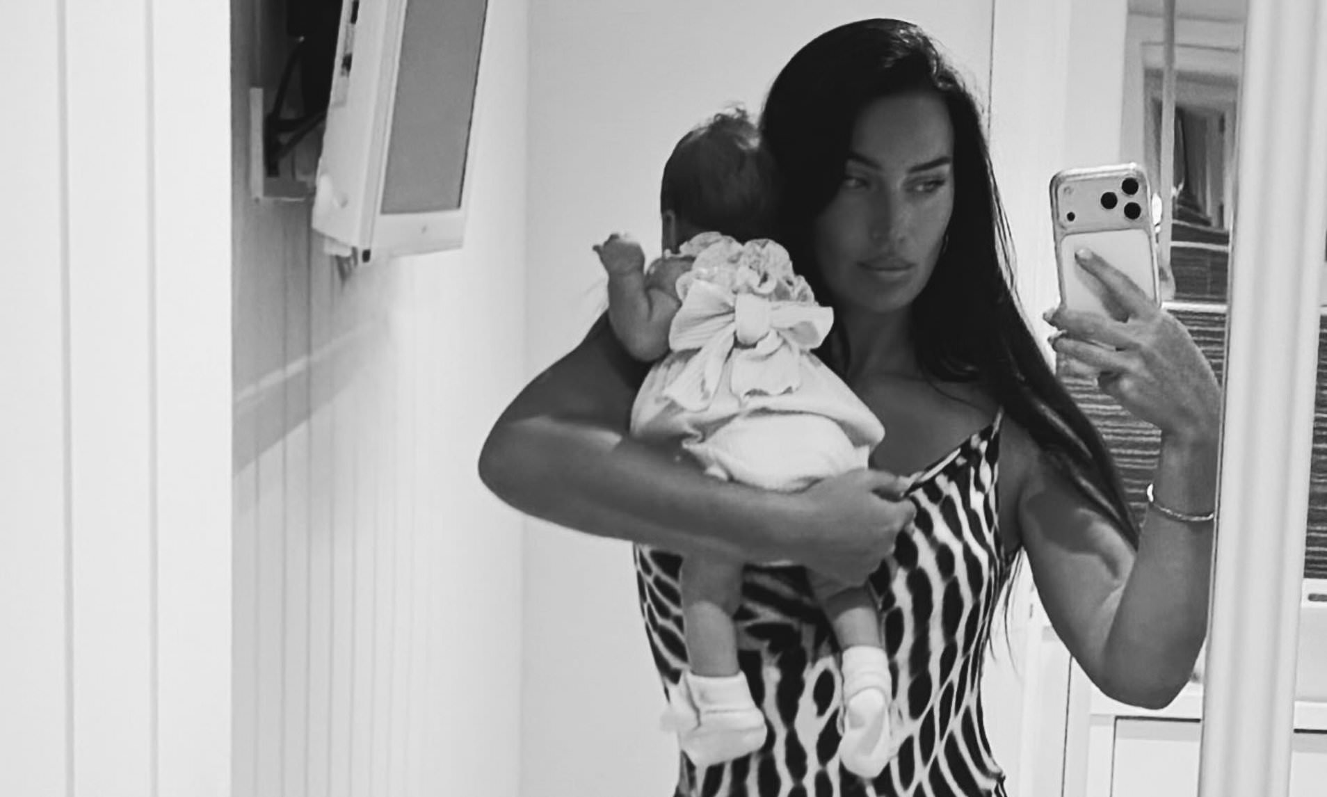 Annie Kilner shares first look at her newborn daughter as she cuddles her in a sweet snap