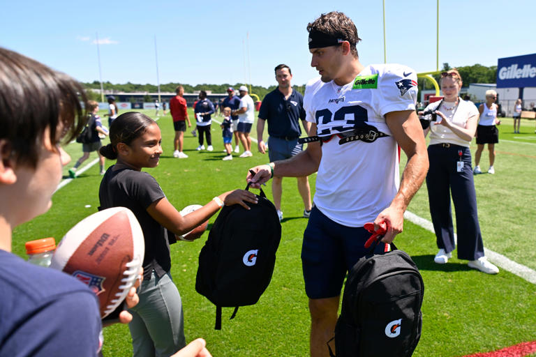 Patriots players surprise Woonsocket youths with school gear