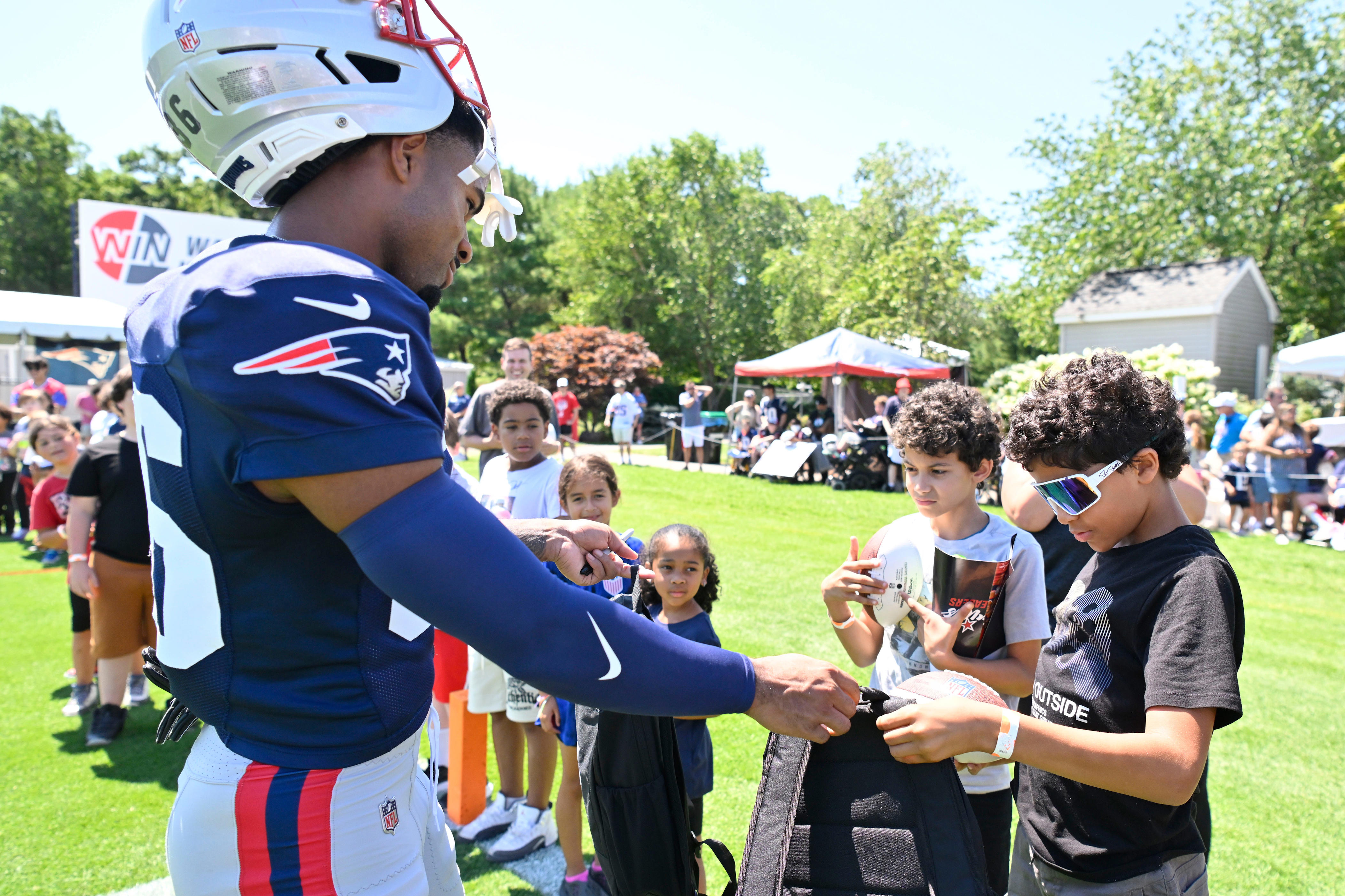 Patriots players surprise Woonsocket youths with school gear