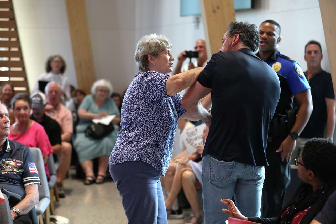 A woman reacts towards former McKinney mayor George Fuller after he spoke during the city council meeting at City Hall in McKinney, Texas, Tuesday evening, August 4, 2026. The council was voting on the site plan for a mosque submitted by the McKinney Islamic Association. (Anja Schlein/The Dallas Morning News)