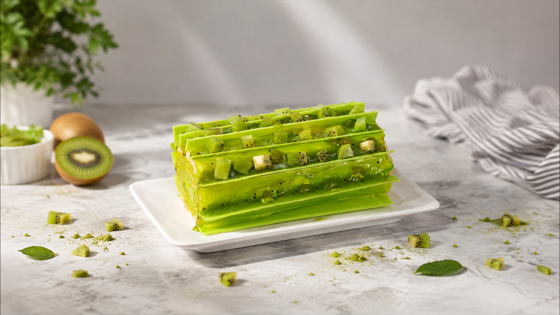 Bright kiwi roll cake with glossy kiwi topping