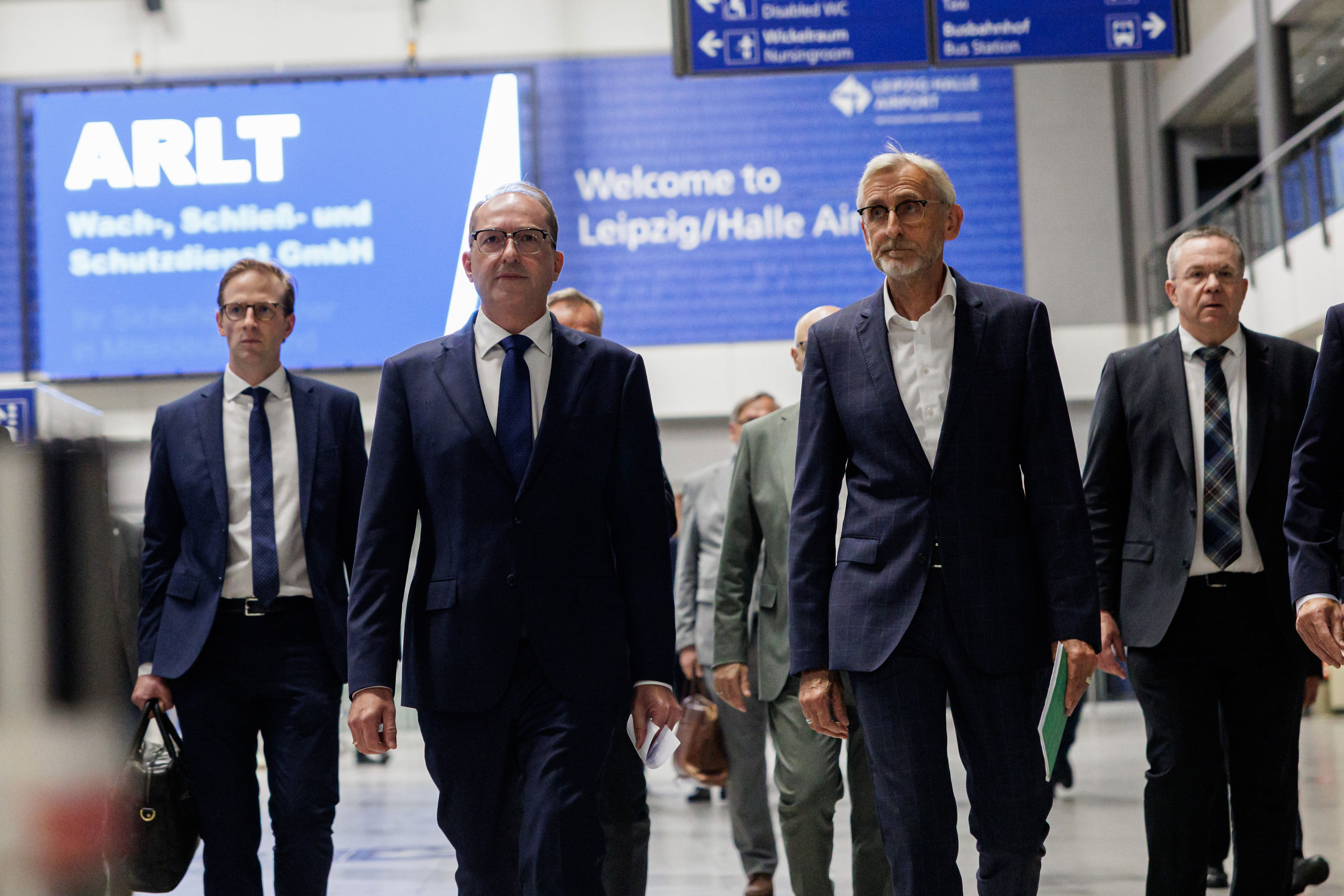 German Interior Minister Alexander Dobrindt (C-L) and Saxony's Interior Minister Armin Schuster (C-R) arrive for a news conference at Leipzig/Halle Airport (Getty)
