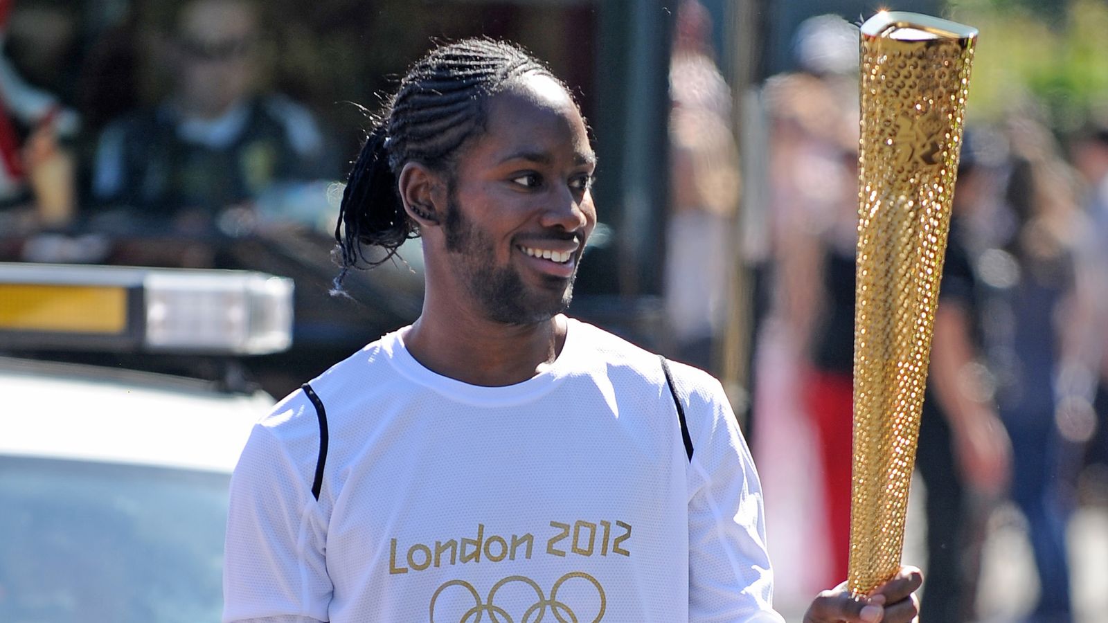 Jason Arday carries the Olympic flame in 2012. Pic: PA