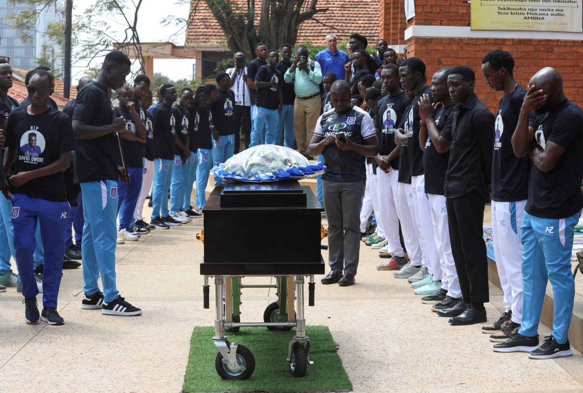 Ugandan soccer players pay homage to the 27-year-old at his funeral (Picture: Reuters)