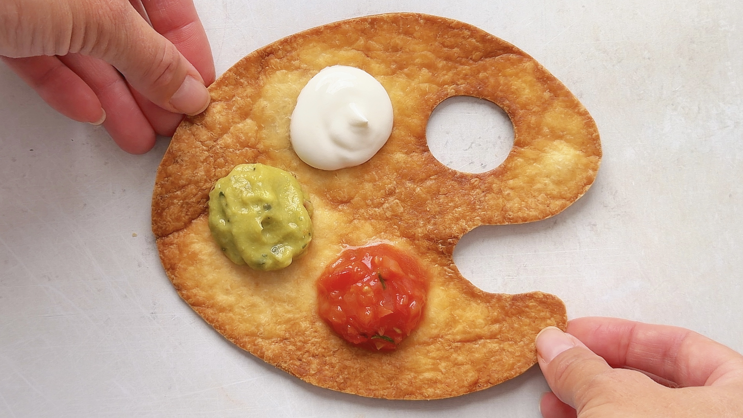 Crispy nacho palette with salsa, guacamole, and sour cream