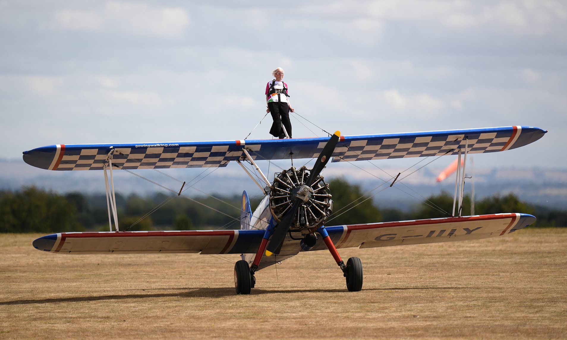 Betty, 97, becomes oldest female wingwalker after being strapped to biplane and flown upside down