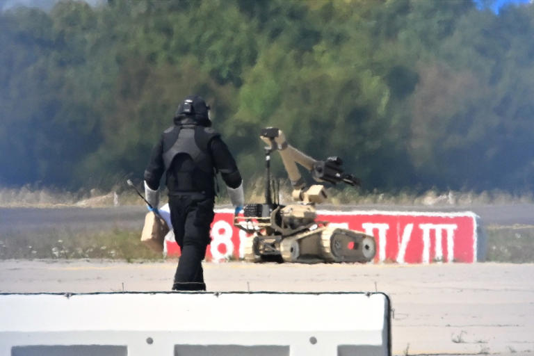 Bomb-disposal specialists deployed a robot at the airport Wednesday.