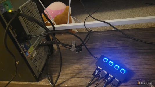 A bunch of USBs with a USB hub plugged into the back of a computer