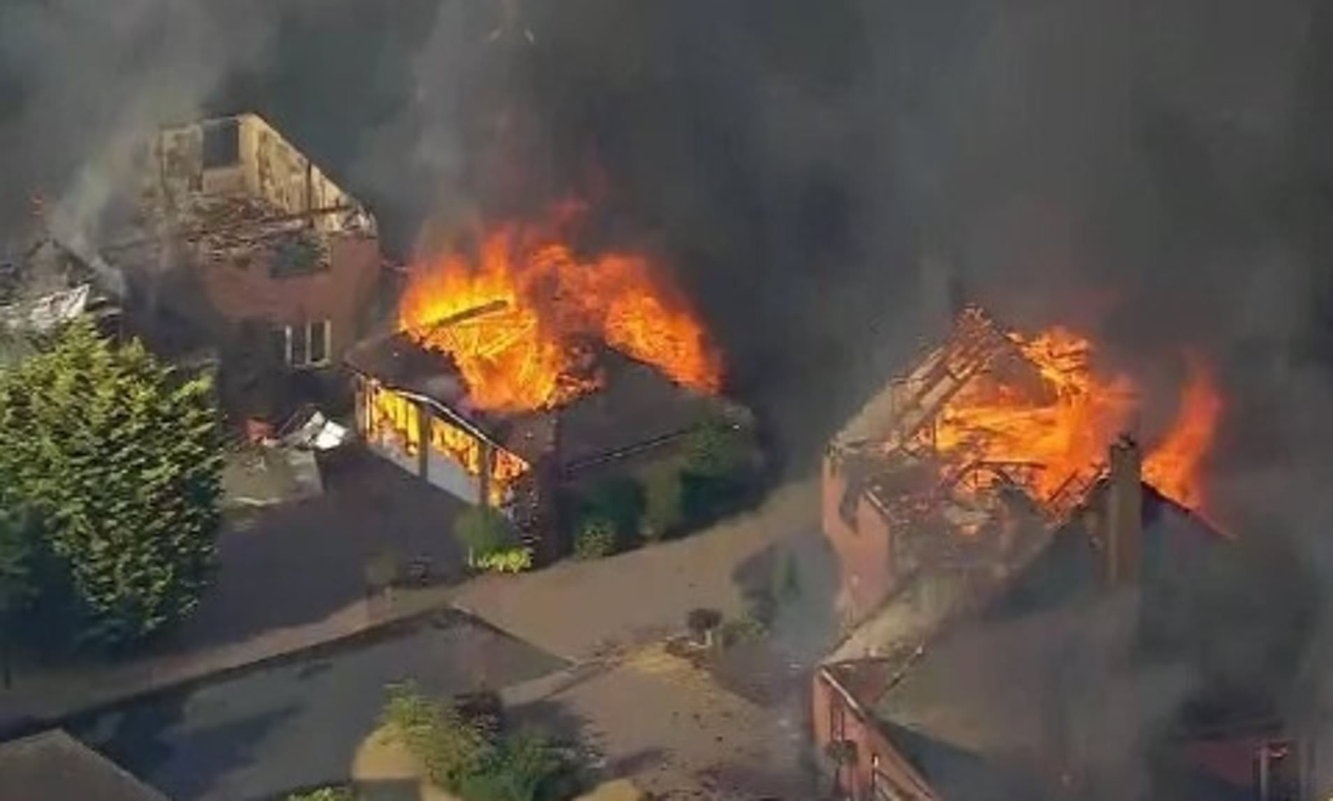 On the hottest day of the year, rampant wildfires engulf streets of family homes across the country