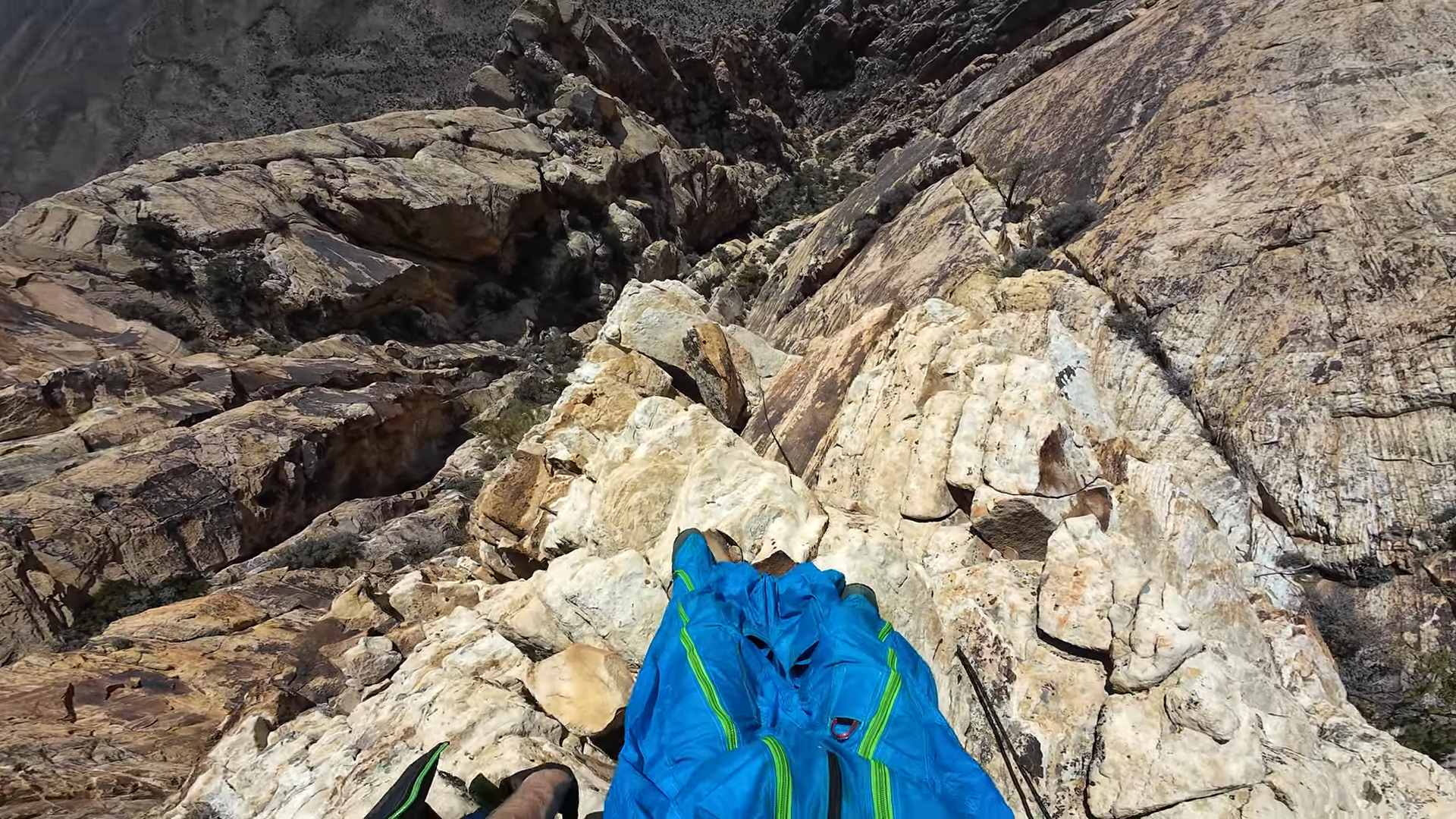 He stands above a brutal desert gully then throws himself into it