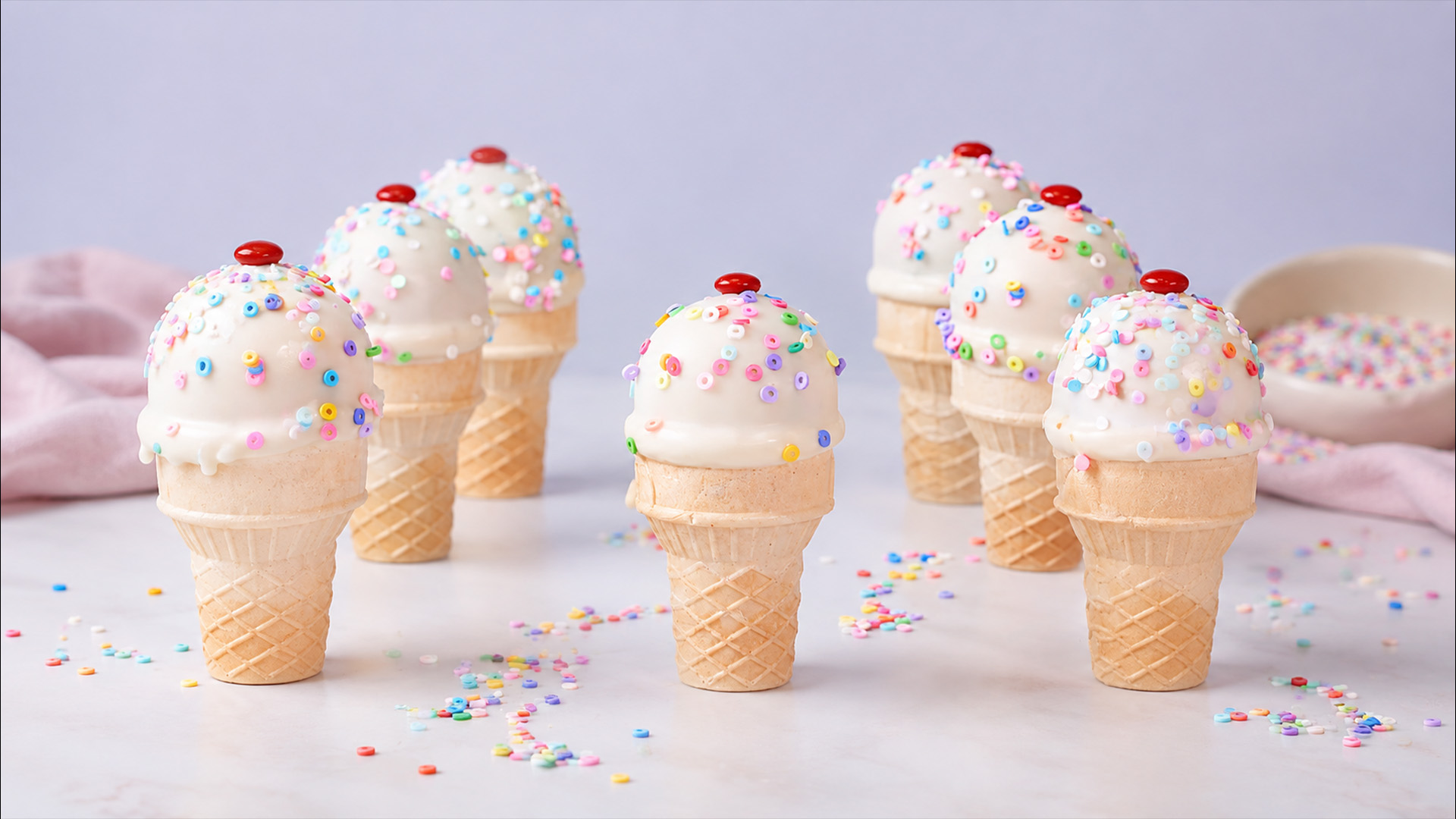 Waffle cone desserts with a sprinkle covered top