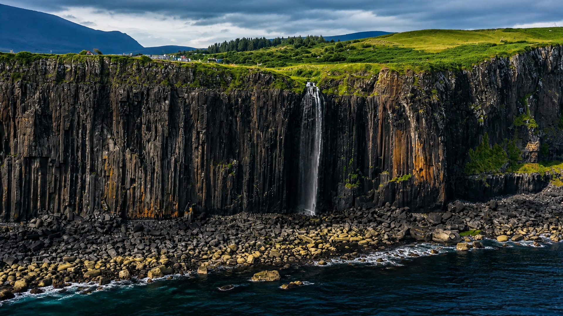 One waterfall cuts through this dark cliff