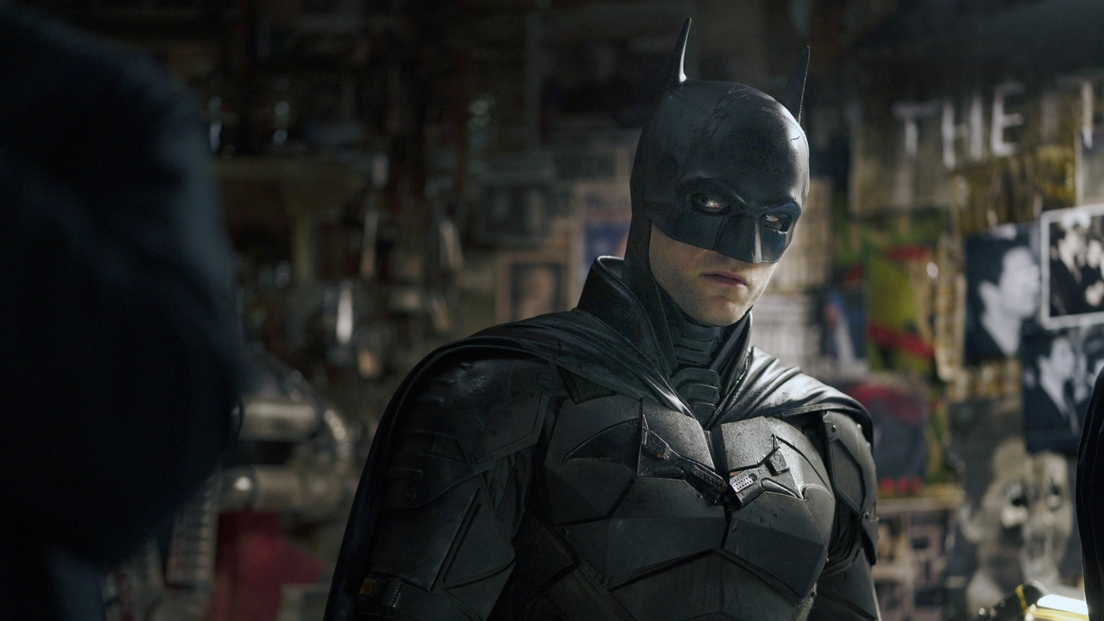 Robert Pattinson finds his way through a crowd of protesters as Bruce ...