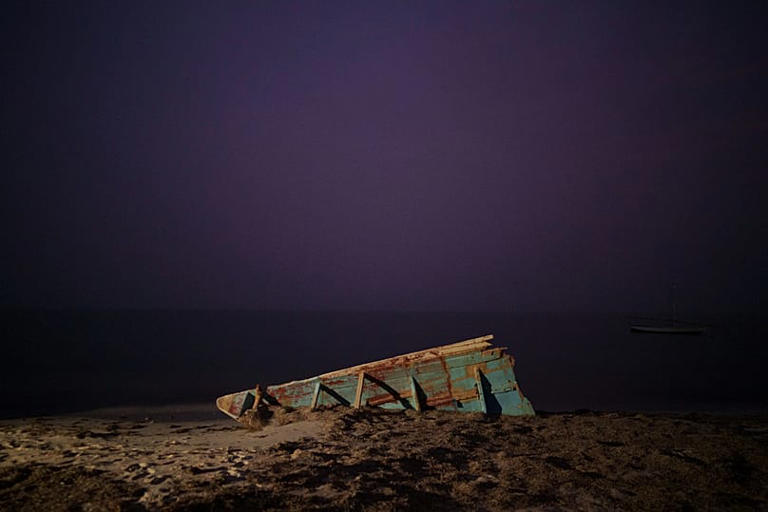 The wreck of a traditional Mauritanian fishing boat, known as a pirogue, on a beach near Nouadhibou, 2 December, 2021 AP Photo