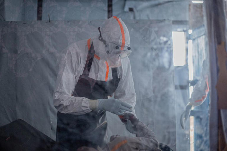A doctor provides care to a patient with Ebola virus disease at the Rwampara Ebola Treatment Centre (ETC) in Bunia, Ituri, in the east of the Democratic Republic of Congo