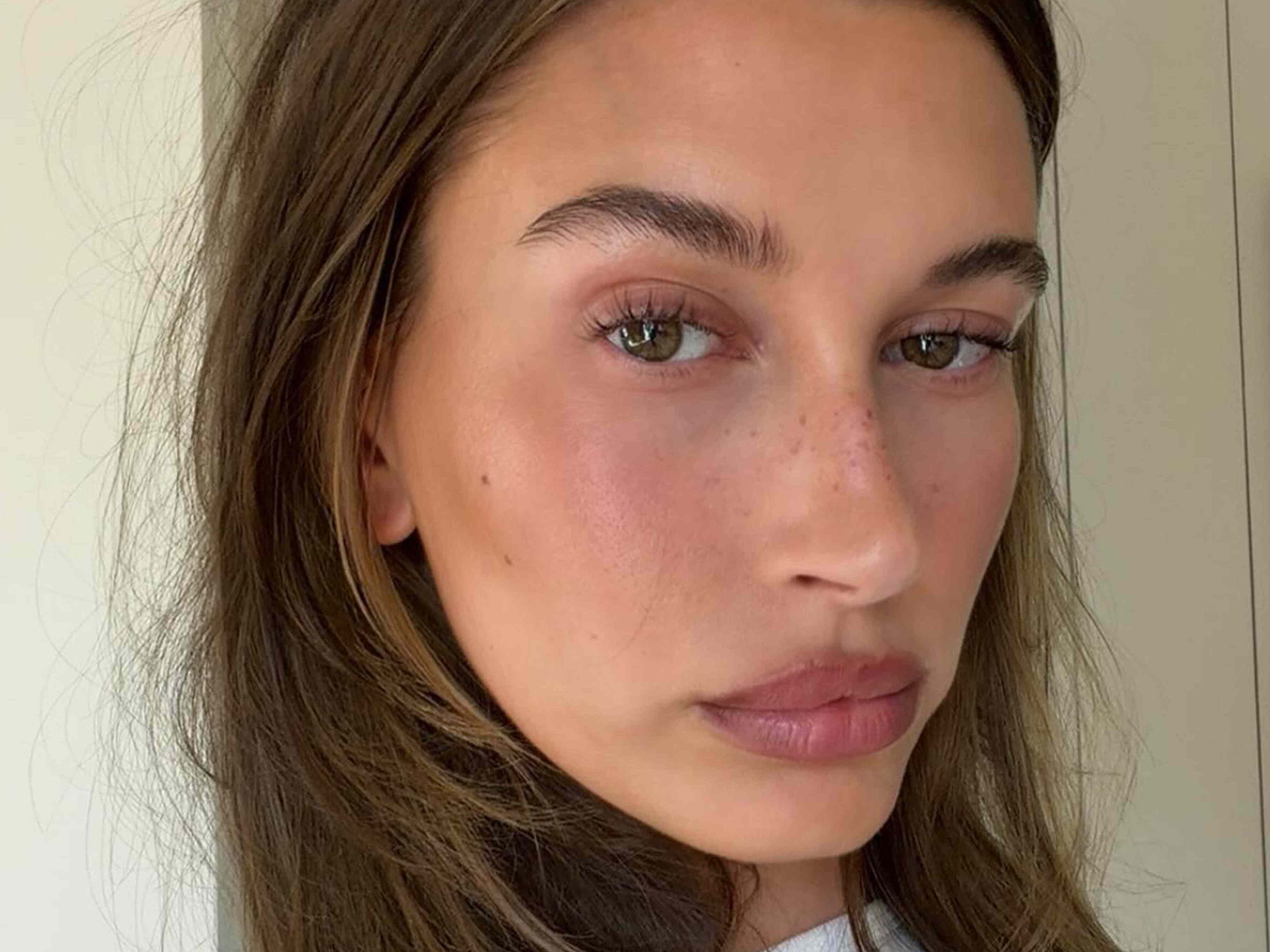 Hailey Bieber wore a basic white T-shirt and cool-girl jeans from her Gap collection to a Dodgers game
