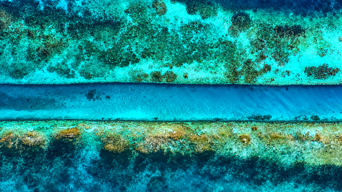 A natural blue channel cutting through a tropical reef