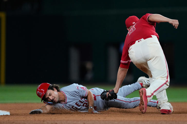 Scoreless through 9, Rangers beat Angels 2-1 as Langford has tying RBI ...
