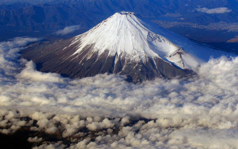 Depicted by Japanese artists including Hokusai, Mt Fuji’s distinctive, snow-capped cone is a national icon - Itsuo Inouye/AP