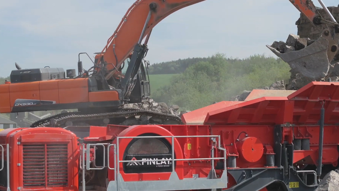 Giant excavator feeding a massive rock crusher